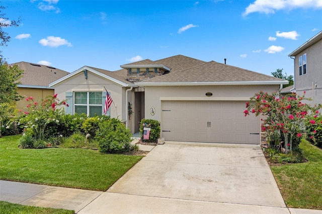 view of front of property featuring stucco siding, a front lawn, roof with shingles, concrete driveway, and a garage