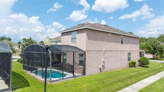 back of house with a yard and a lanai