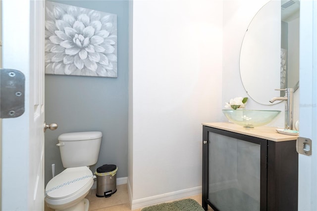 bathroom featuring tile patterned flooring, vanity, and toilet