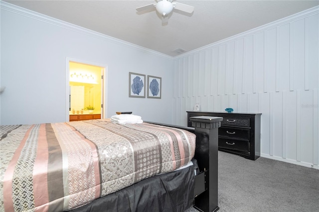 carpeted bedroom with ceiling fan, ensuite bath, and ornamental molding