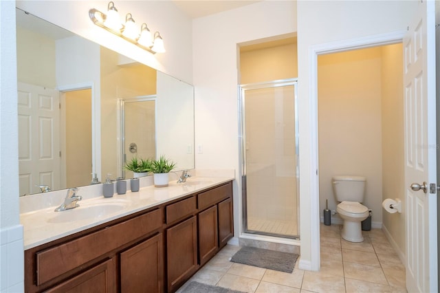 bathroom with toilet, vanity, walk in shower, and tile patterned floors