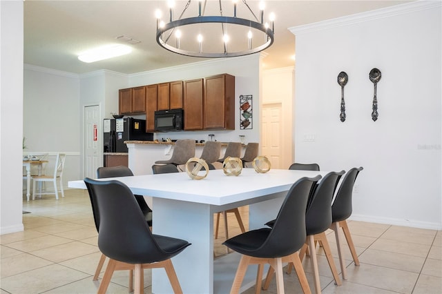 kitchen with a chandelier, ornamental molding, black appliances, a kitchen breakfast bar, and light tile patterned flooring