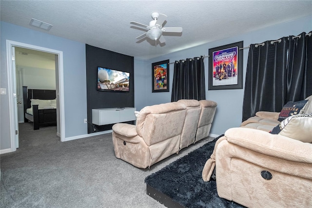 home theater room featuring a textured ceiling, carpet floors, and ceiling fan