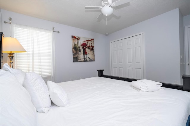 bedroom featuring ceiling fan and a closet