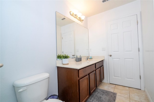 bathroom with tile patterned floors, vanity, and toilet