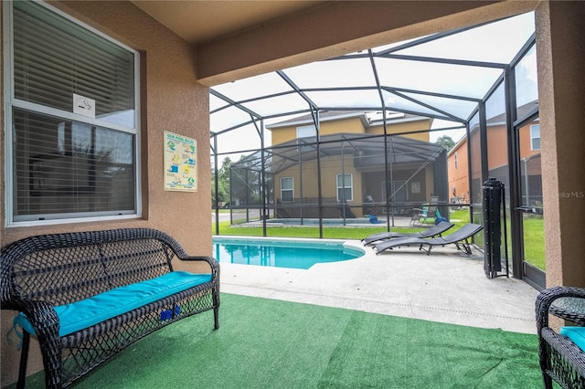 view of pool featuring glass enclosure, a patio area, and a yard