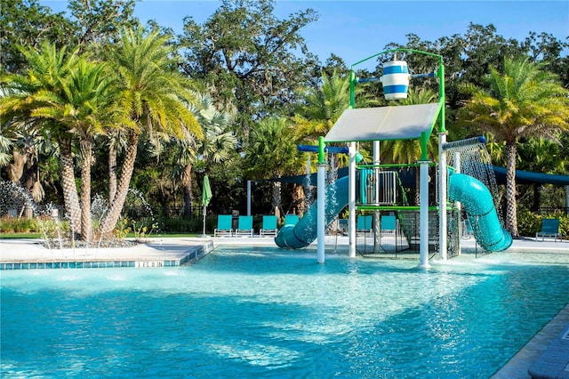 view of pool with a playground and pool water feature