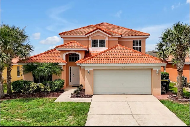 mediterranean / spanish-style home featuring a tile roof, stucco siding, an attached garage, and concrete driveway