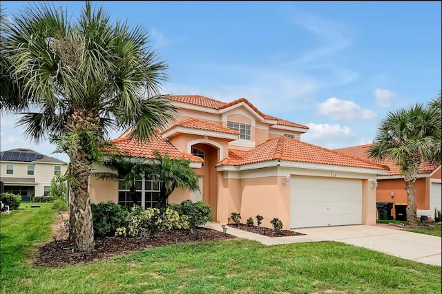 mediterranean / spanish house with a garage and a front yard