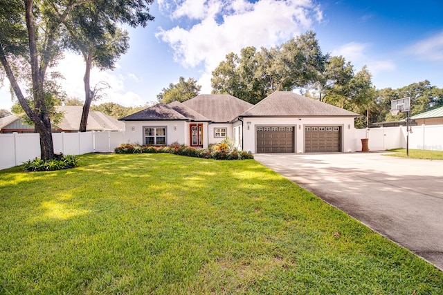 view of front facade featuring a garage and a front lawn