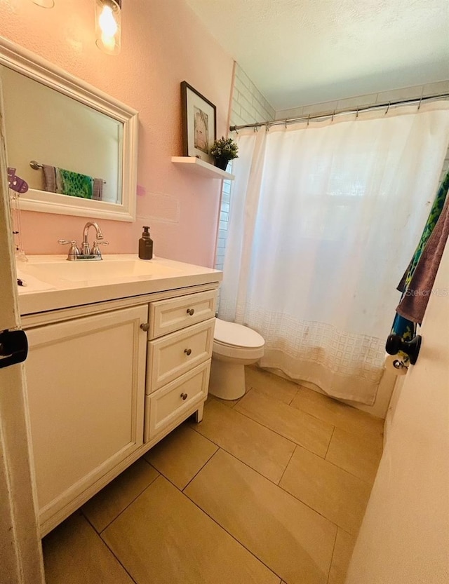 bathroom featuring toilet, curtained shower, and vanity