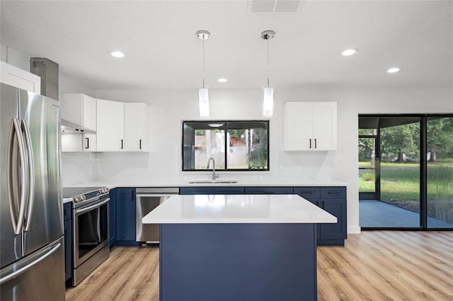 kitchen with visible vents, light countertops, light wood-style flooring, appliances with stainless steel finishes, and a sink