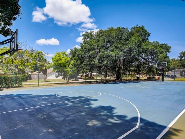 view of basketball court with community basketball court and fence