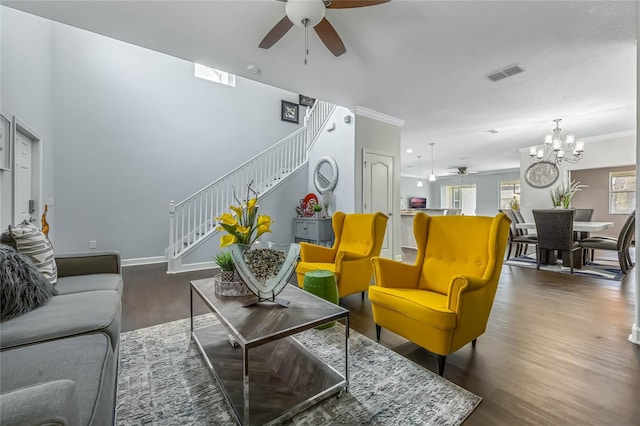 living room with ceiling fan with notable chandelier, crown molding, and dark hardwood / wood-style floors