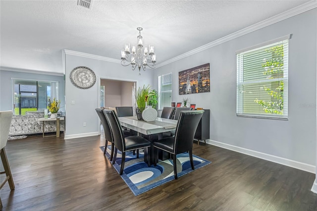 dining room with crown molding, dark wood-type flooring, a textured ceiling, and a chandelier