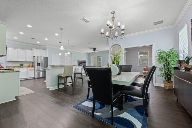 dining area with ceiling fan with notable chandelier, a textured ceiling, ornamental molding, and dark hardwood / wood-style floors