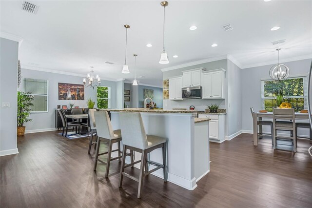 kitchen with dark wood-type flooring, an inviting chandelier, and decorative light fixtures