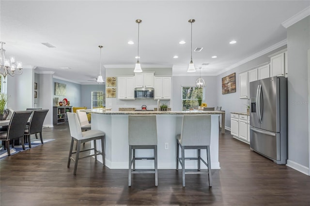 kitchen featuring dark wood-type flooring, stainless steel appliances, a notable chandelier, and hanging light fixtures