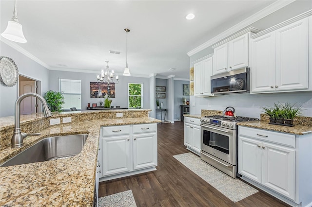 kitchen featuring dark hardwood / wood-style flooring, appliances with stainless steel finishes, ornamental molding, sink, and white cabinetry