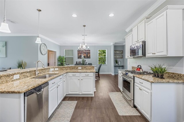 kitchen featuring an island with sink, dark wood-type flooring, stainless steel appliances, sink, and white cabinetry