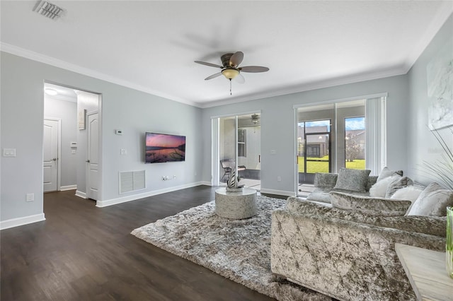 living area featuring visible vents, dark wood-type flooring, and ornamental molding