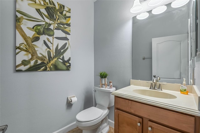 bathroom with vanity, toilet, and tile patterned flooring