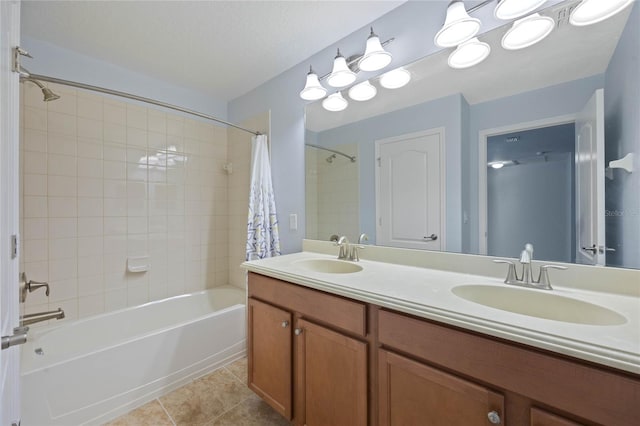 bathroom featuring tiled shower / bath combo, vanity, and tile patterned flooring