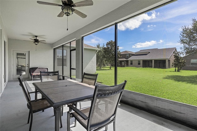 sunroom featuring ceiling fan