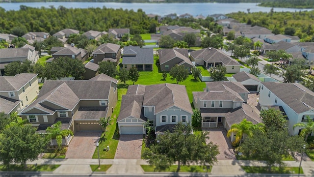 birds eye view of property with a water view and a residential view