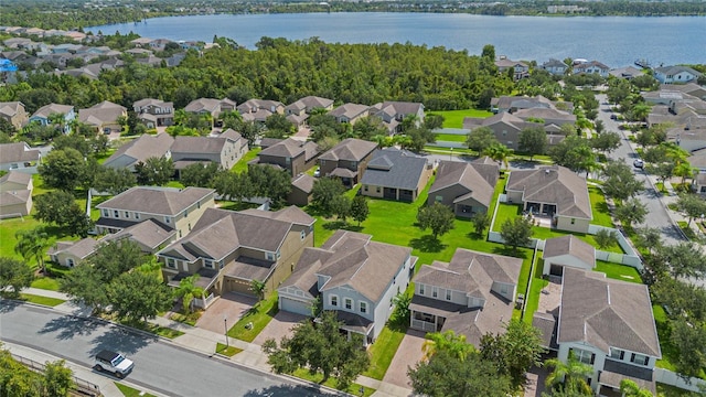 drone / aerial view with a residential view and a water view