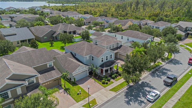 drone / aerial view with a residential view and a water view