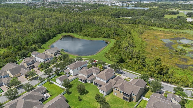 aerial view featuring a residential view, a water view, and a wooded view