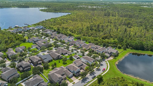 aerial view with a residential view, a water view, and a forest view