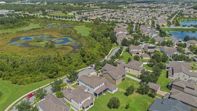 drone / aerial view with a water view and a residential view