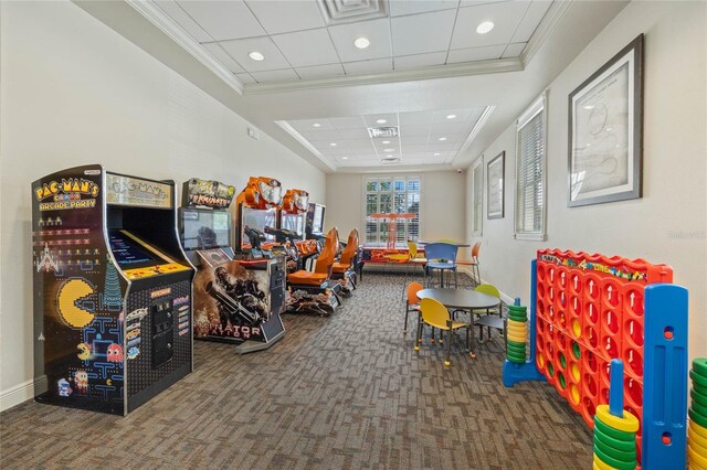 game room with dark carpet, a paneled ceiling, a tray ceiling, and crown molding