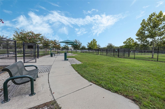 surrounding community featuring fence and a yard