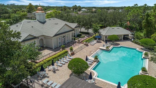 community pool featuring a patio and fence