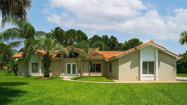 rear view of property featuring a yard