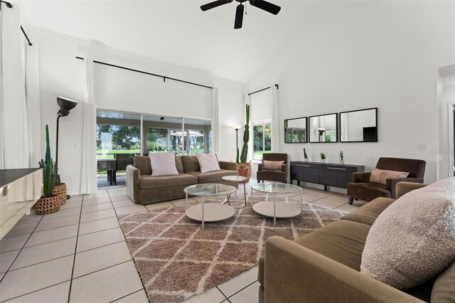 living room with ceiling fan, light tile patterned floors, and high vaulted ceiling