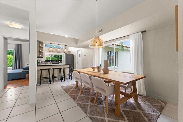 dining area with light tile patterned flooring and a wealth of natural light