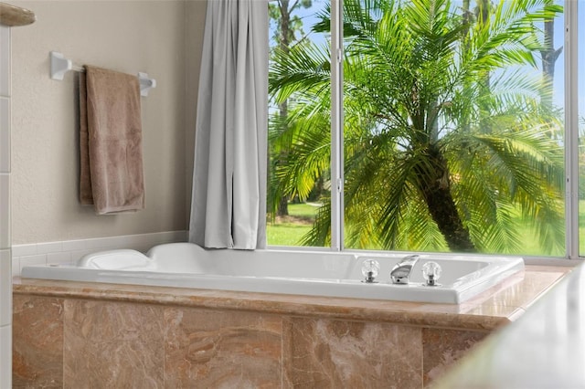 bathroom featuring a relaxing tiled tub