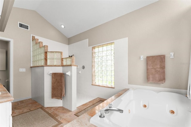 bathroom with vaulted ceiling and independent shower and bath