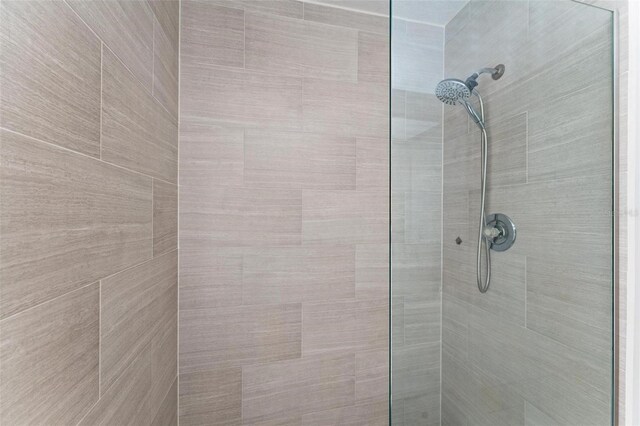 interior details featuring a tile shower