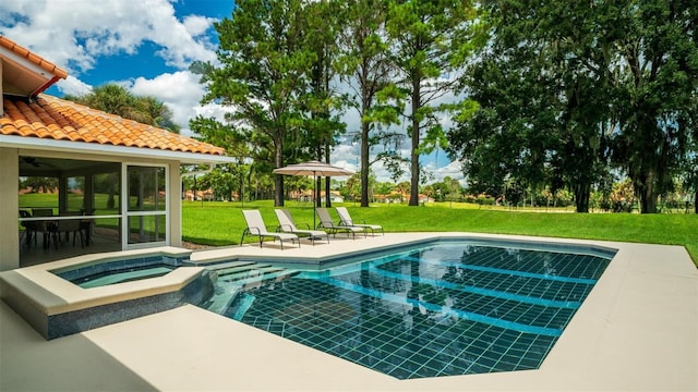 view of pool featuring a patio, a lawn, and an in ground hot tub