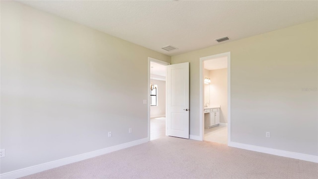 carpeted spare room with a textured ceiling