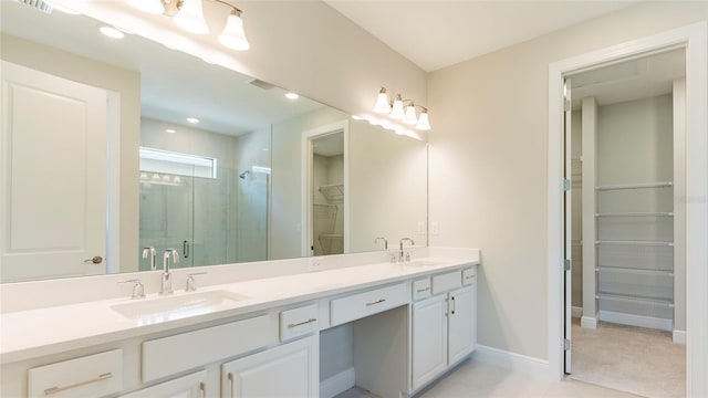 bathroom with a shower with door and vanity