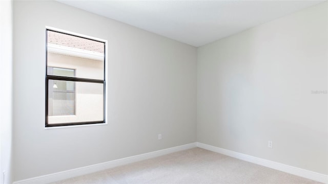 unfurnished room with a healthy amount of sunlight and light carpet