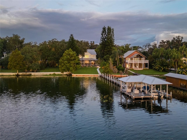 dock area featuring a water view and a yard