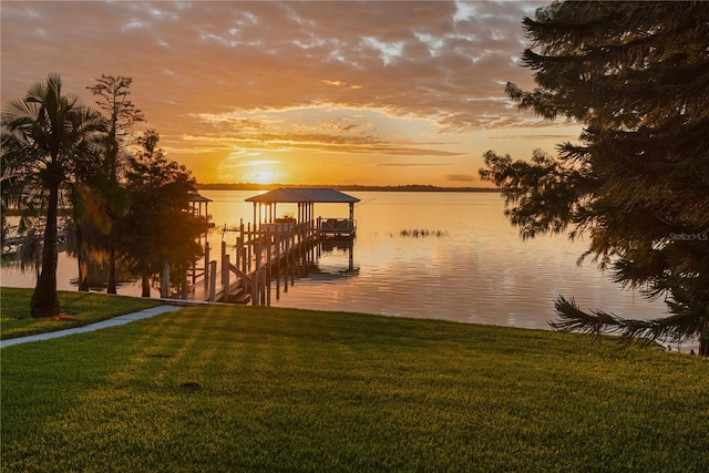 dock area featuring a yard and a water view