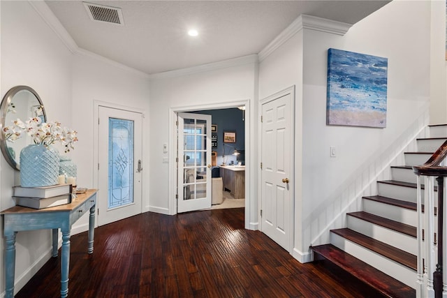 entrance foyer with ornamental molding and dark hardwood / wood-style flooring